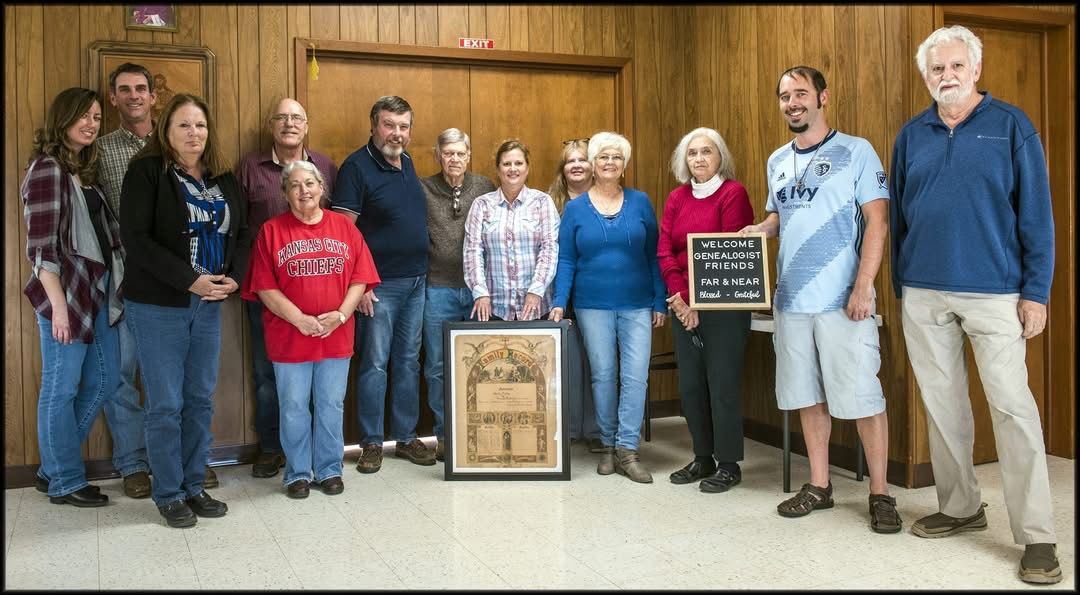 Group of preservation volunteers holding framed historic documents
